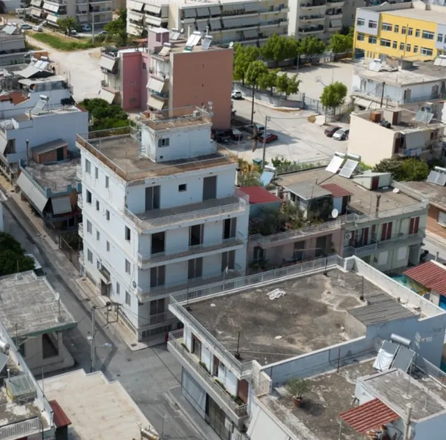 Drone photograph of the MVR 19 rooftop and the surrounding blocks of south Patras